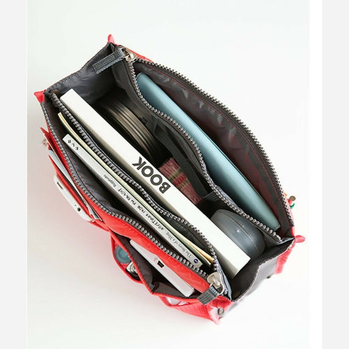 A bag organiser with books and other items inside