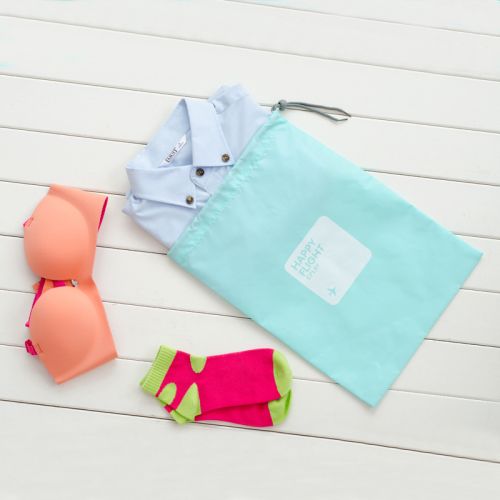 Light blue travel pouch used for travel to pack shirt, socks and bra