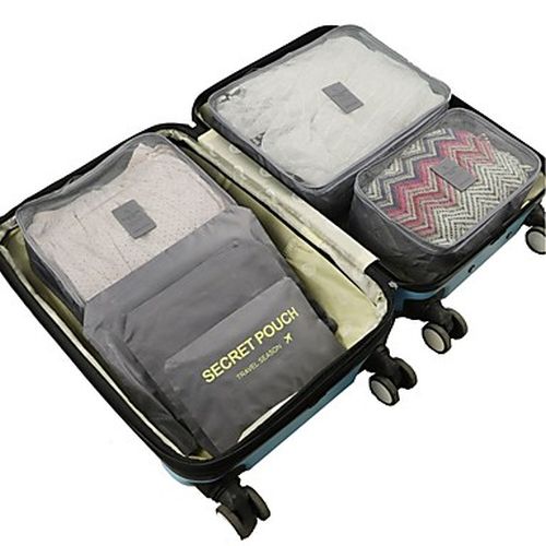 Grey packing cubes inside a suitcase