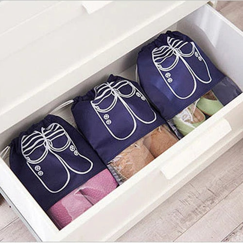 3 pairs of shoes inside a drawer protected using dark blue shoe pouches