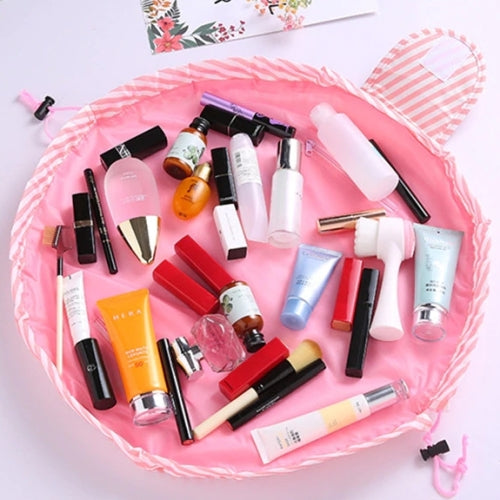 Pink and white striped Scrunch Up Makeup Bag laid out flat with cosmetics inside