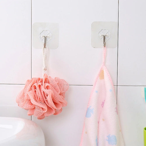 Body loofah and towel hanging on tiled wall using clear adhesive wall hooks