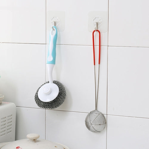 Kitchen utensils hanging on tiled wall using clear adhesive wall hooks