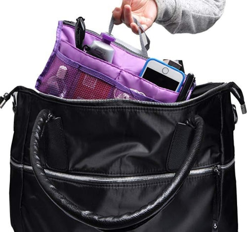 Bag organiser insert being placed inside a black tote bag