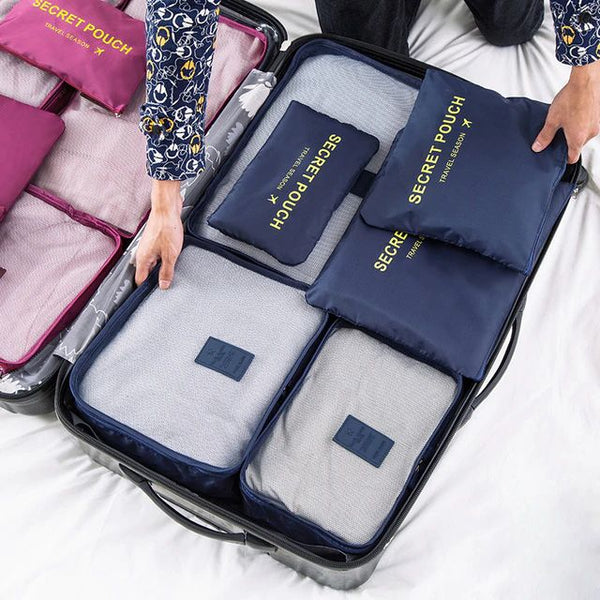 Navy blue packing cubes inside a suitcase